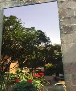 304 grade mirror stainless steel sheet reflecting brick wall and window